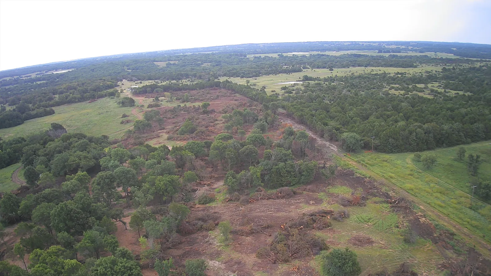 Aerial view of land clearing progress across an Oklahoma ranch tract