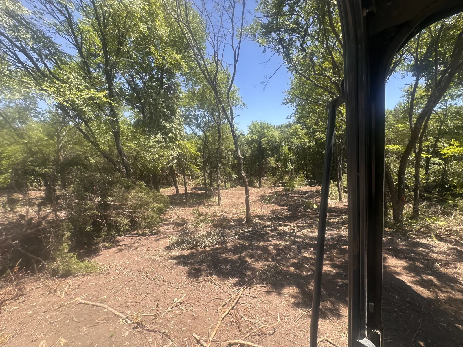 Cab view of a cleared fence line corridor ready for a new fence build