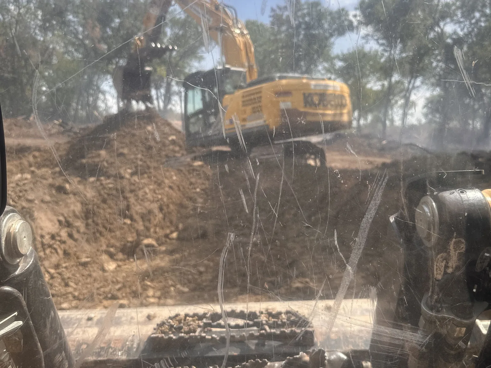 The pond cut seen from the excavator cab