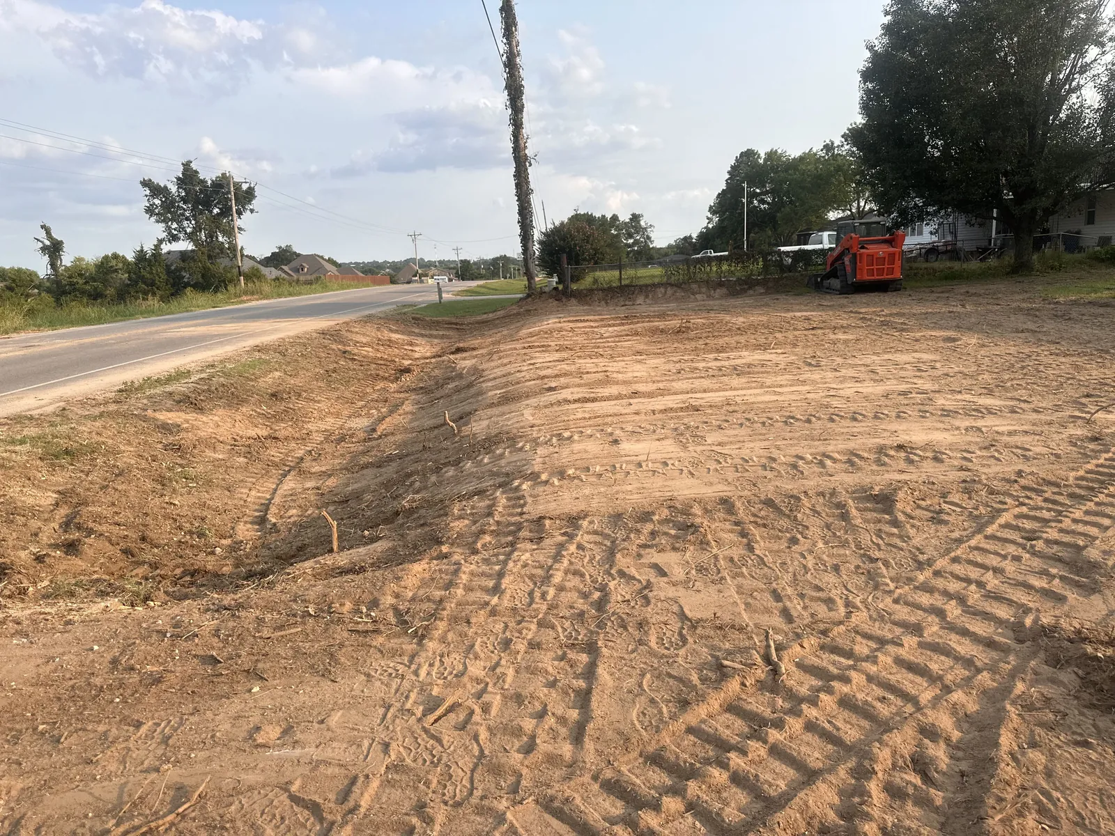 Fresh graded drive with tire tracks holding the crown