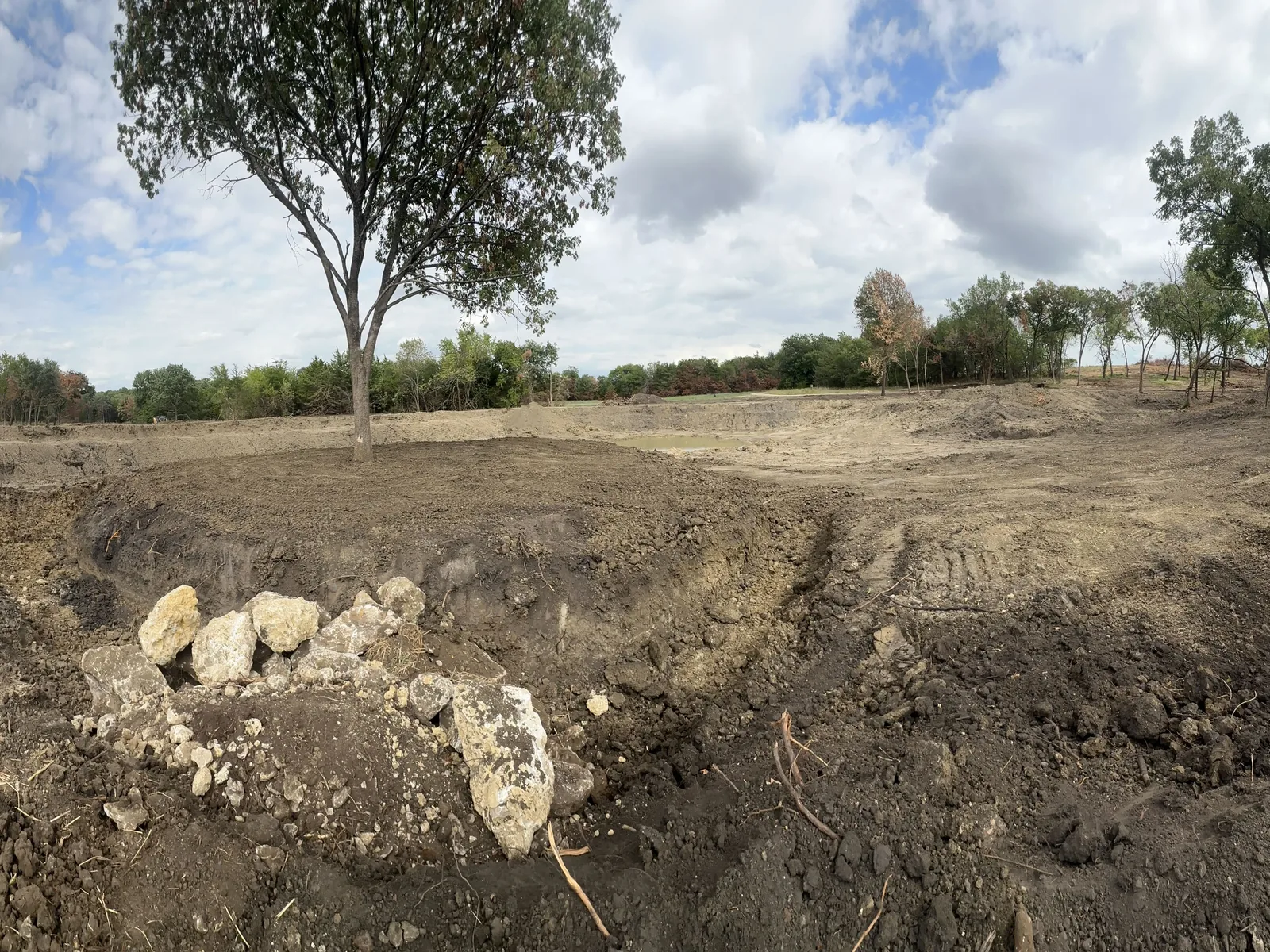 A pond basin cut to shape with the spoil banked around it