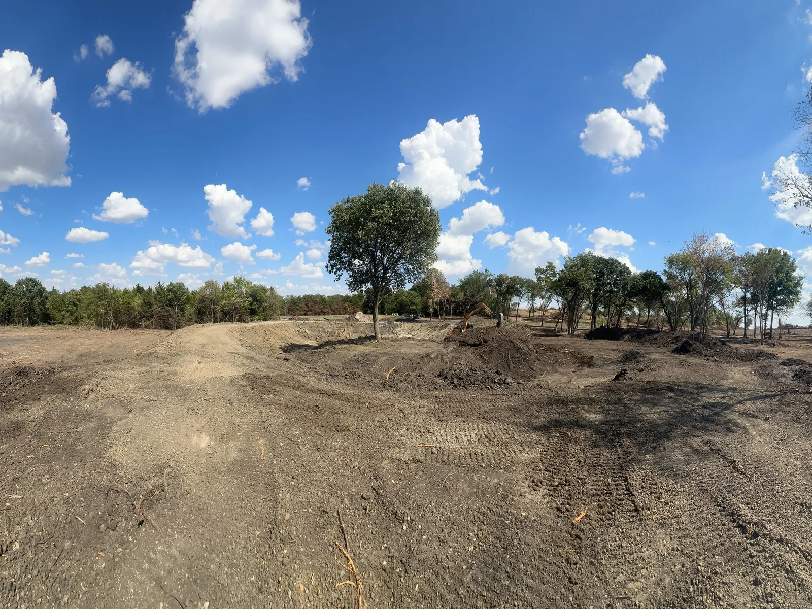 Wide view of the pond site with the banks cut and the spoil pushed back