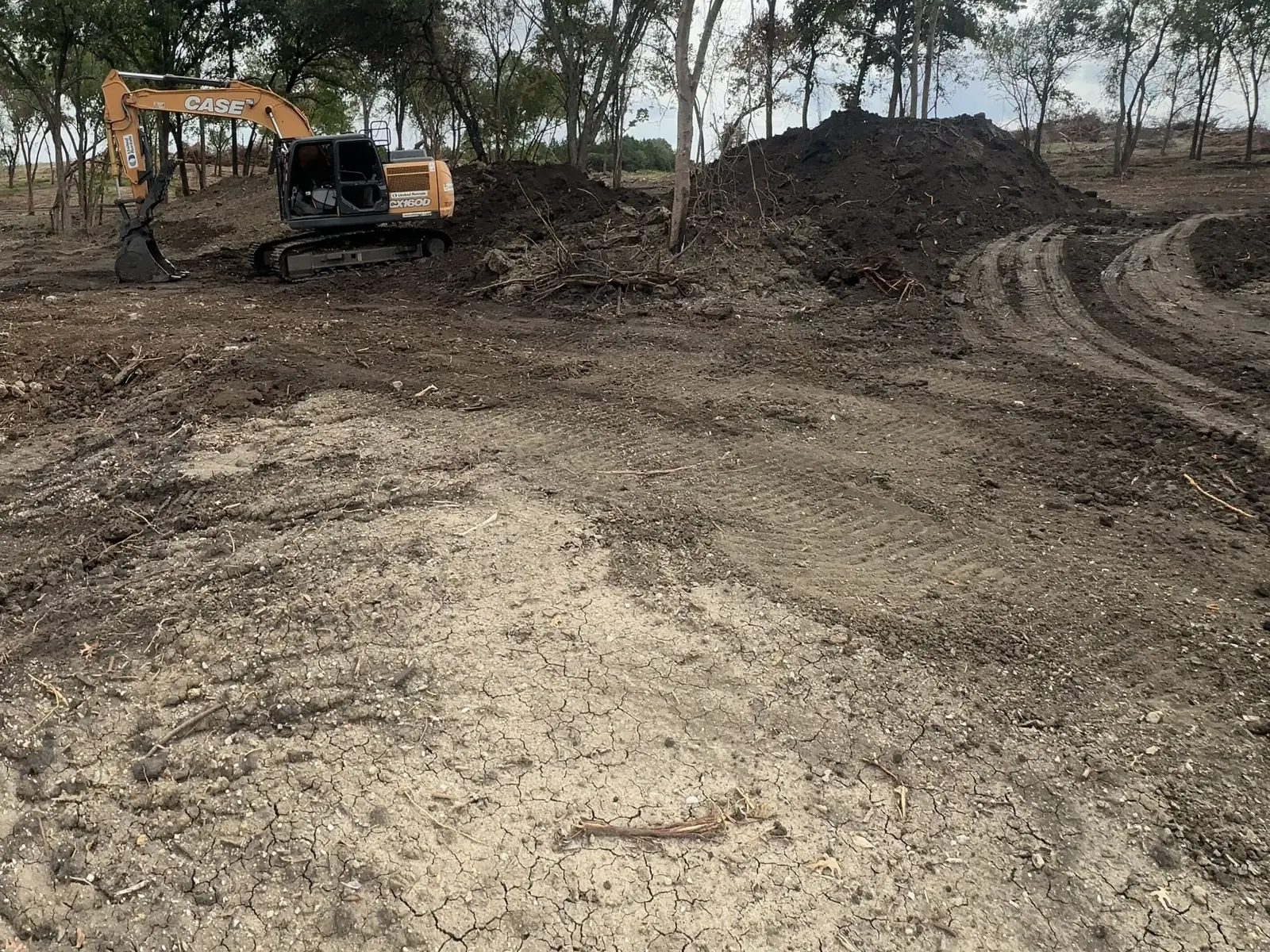 An excavator digging on an Oklahoma property